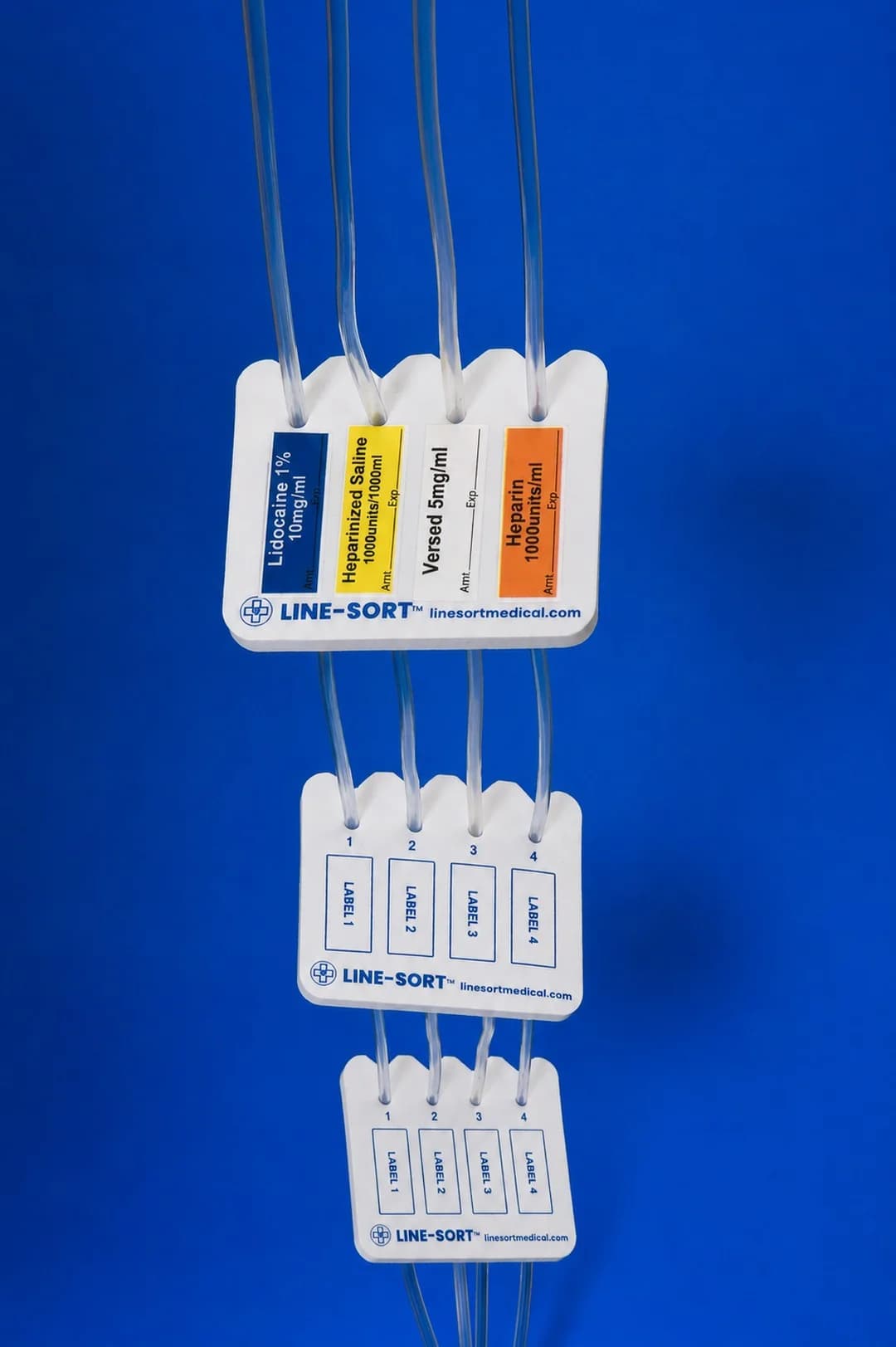Three Line-Sort pads positioned along four IV tubes, with identification labels on the nearest pad