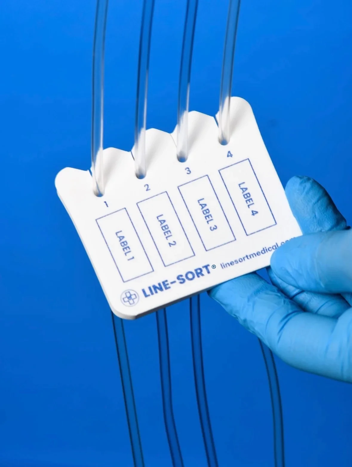 The four open channels and dedicated label areas of a LINE-SORT IV line organizer used with IV tubing